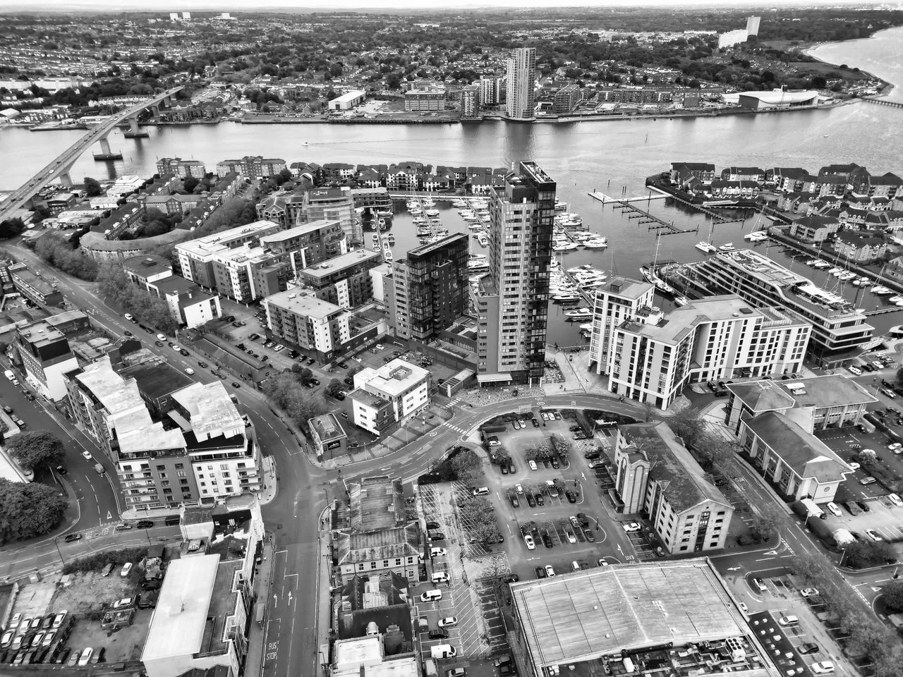 Black and white aerial view of the bustling waterfront and urban landscape of Southampton Marina.
