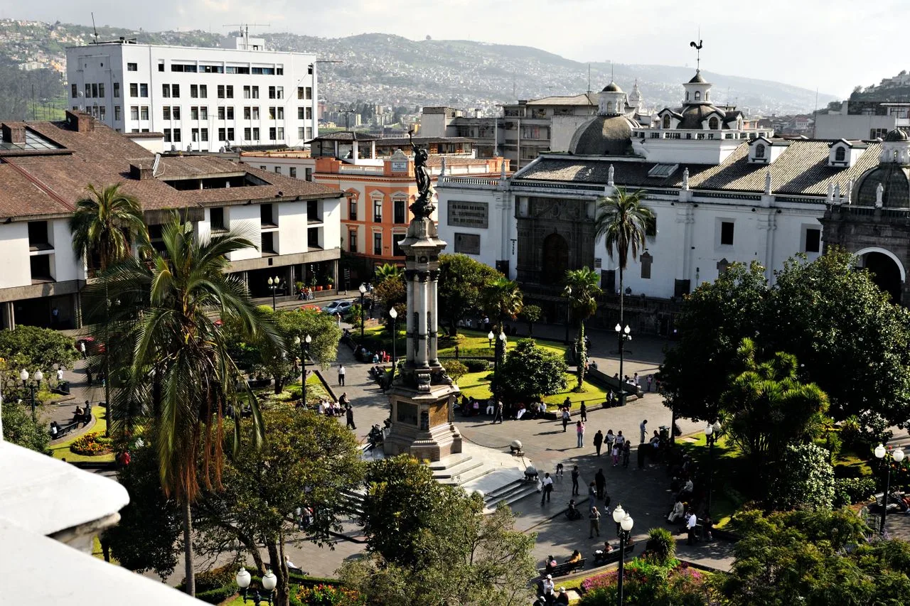 A vibrant aerial view of Plaza Grande in Quito, showcasing historical architecture and lush greenery.