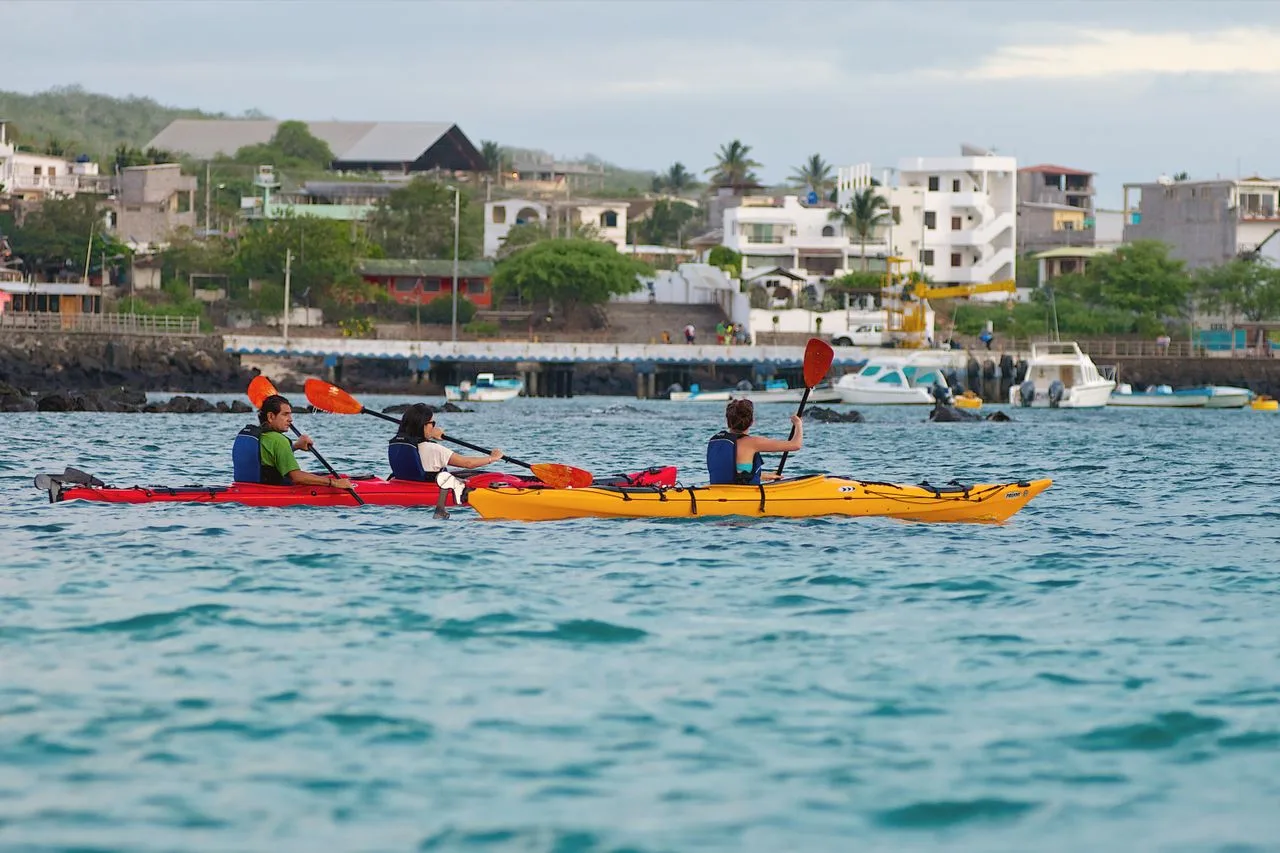 Tourists enjoying a kayaking experience along the coast of Galápagos Islands, Ecuador.