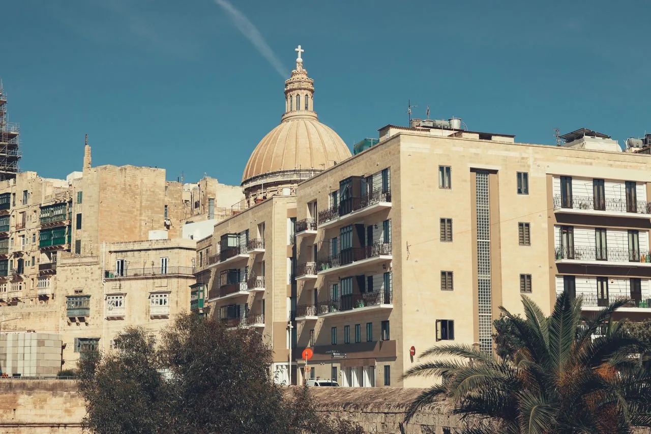Explore the neoclassical architecture and urban landscape of Valletta, Malta, featuring Our Lady of Mount Carmel.