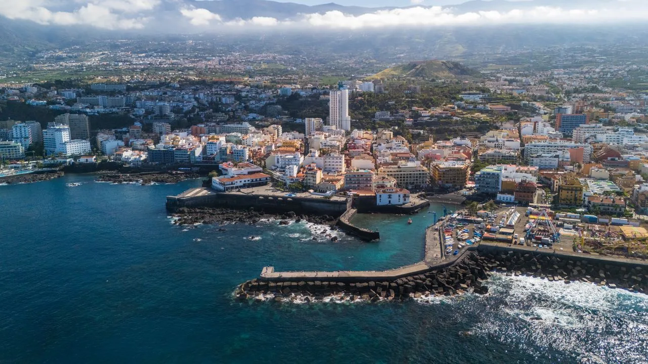Stunning aerial view of Puerto de la Cruz, Tenerife with coastlines and Mediterranean Sea.