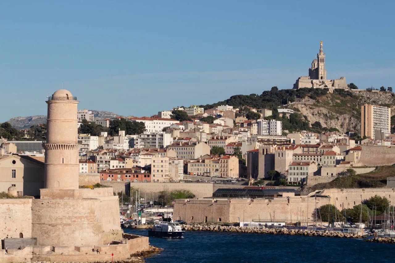 Beautiful daytime view of Marseille featuring Fort Saint-Jean and Notre-Dame de la Garde.