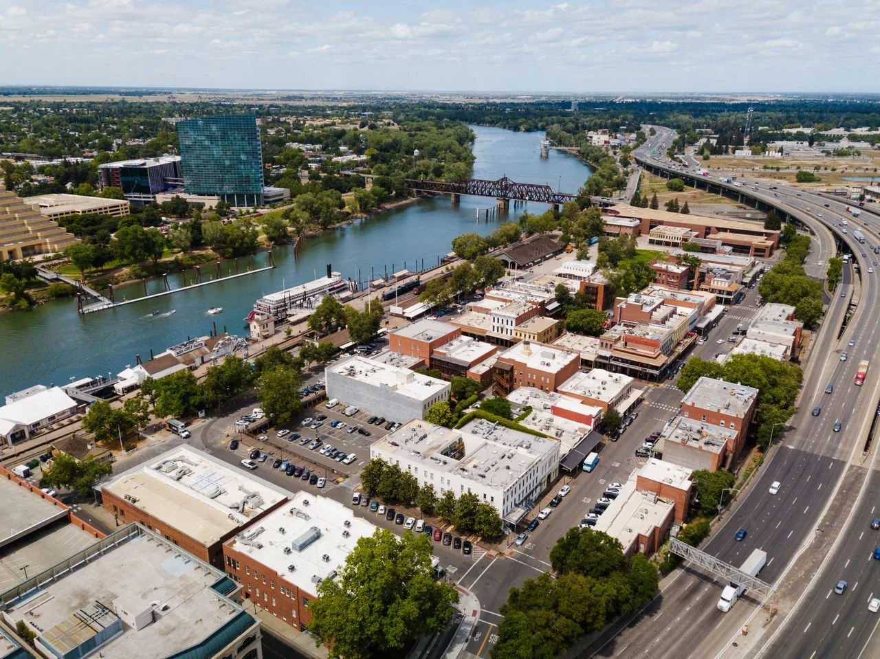 Aerial view showcasing Sacramento city's downtown, river, and urban landscape.