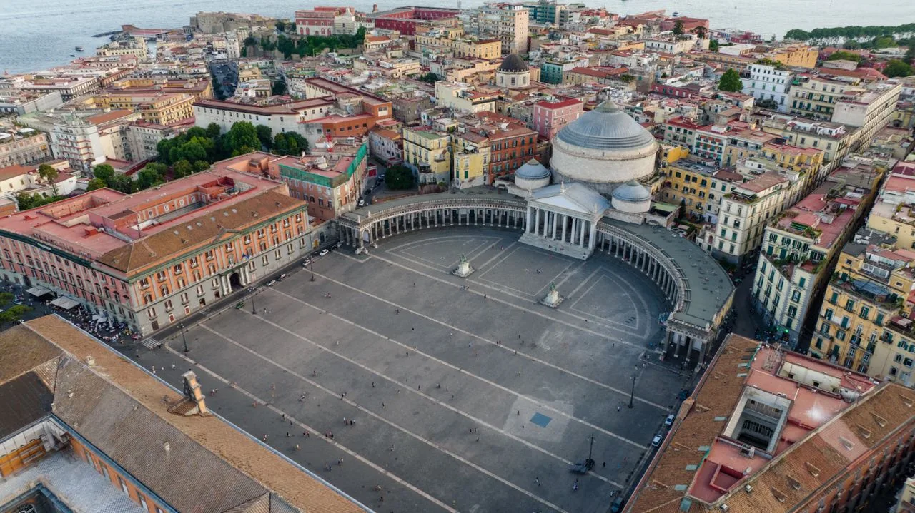 Aerial view of historic Piazza del Plebiscito in Naples, Italy with architectural landmarks.