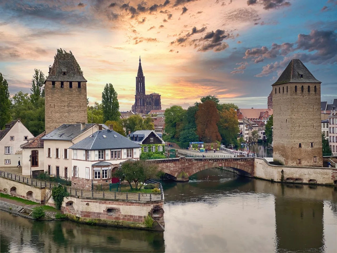 Explore the stunning sunset over Strasbourg's classic bridges and towers.